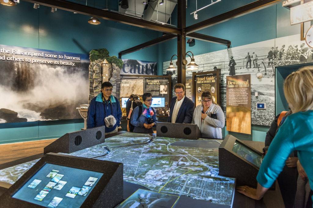 Guests surrounding a digital map table