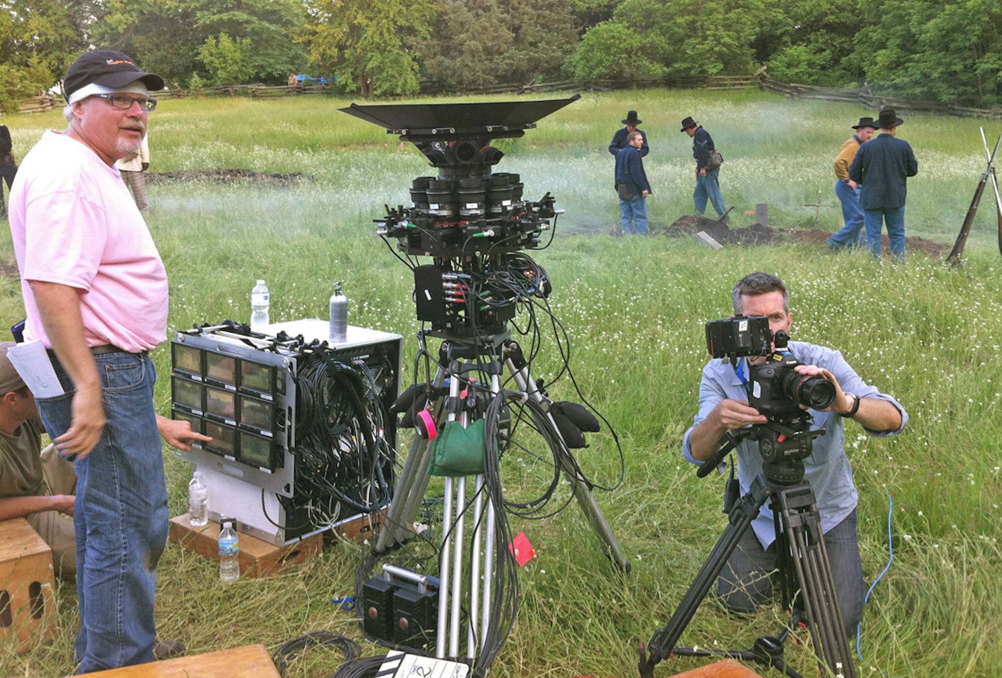 Video production team in the field with camera equipment and historical reenactment actors