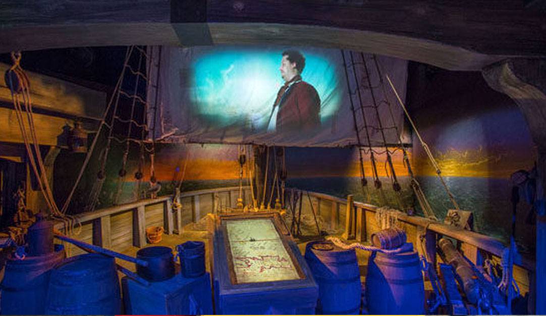 Pirate projected on a sail in an artfully-designed ship deck exhibit