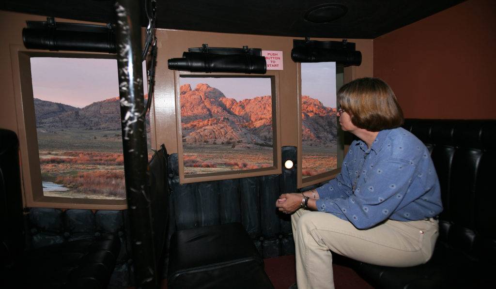 Woman views trail scenery from inside a stagecoach