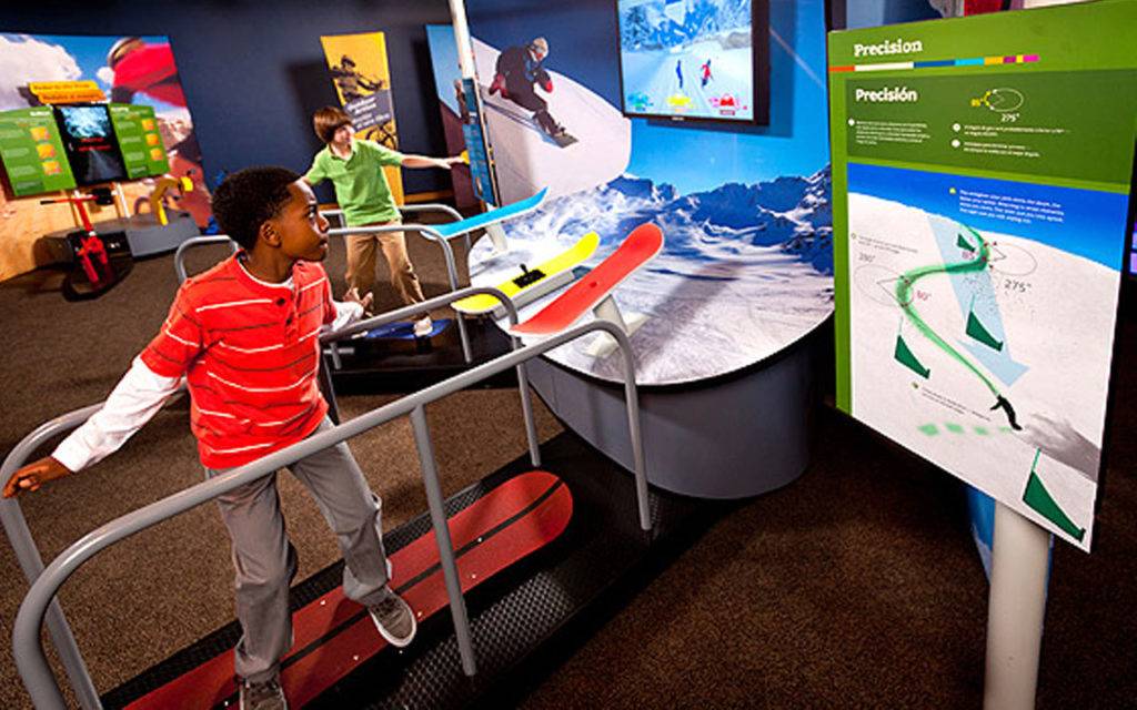 Children balancing on snowboards to control a video game