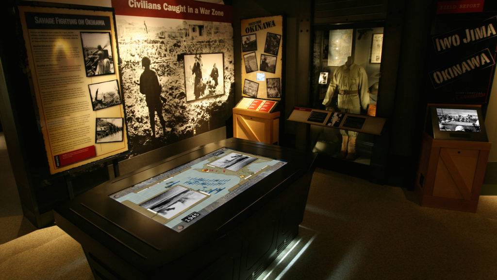Bush Gallery exhibit with battle tactics map table, and display case of military uniform
