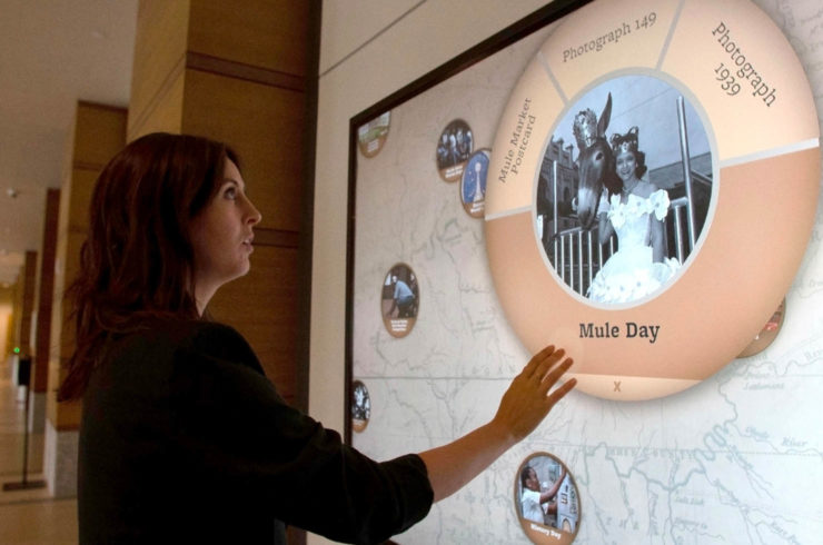 Visitor using with a wall-mounted multitouch interactive at the Tennessee State Library and Archives